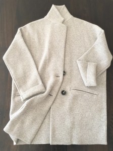 A versatile, light gray sweater with two buttons and a caccoon cut by Madewell