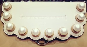 Fendi Faux Pearl Back to School Leather Backpack - close up view of the faux pearl on the front flap