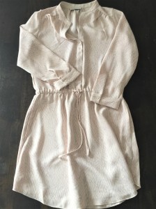 A dress shirt in blush and grey colors by Babaton, an Aritzia brand.
