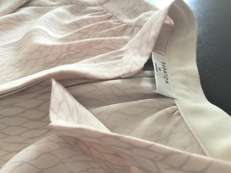 A shirt dress with drawstring in light pink color by Aritzia.