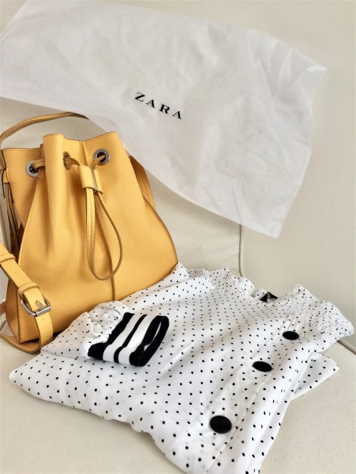 Yellow bucket bag and a black and white polka dot blouse with stripe details from ZARA